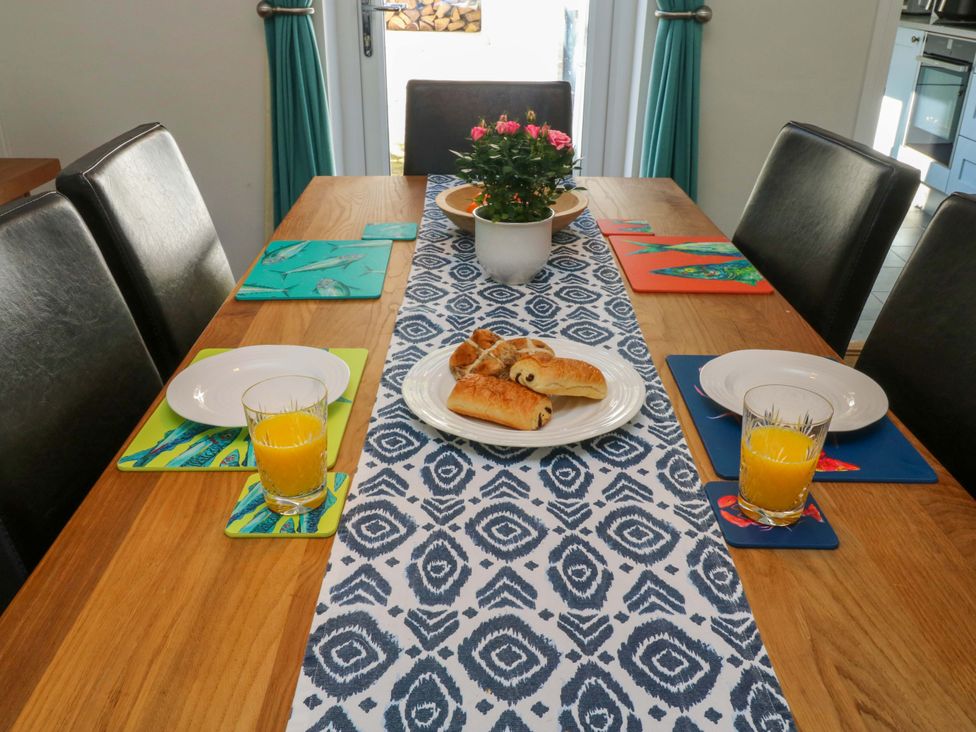 A dining room table set with plates and drinks at 43 Sandquay Road Dartmouth