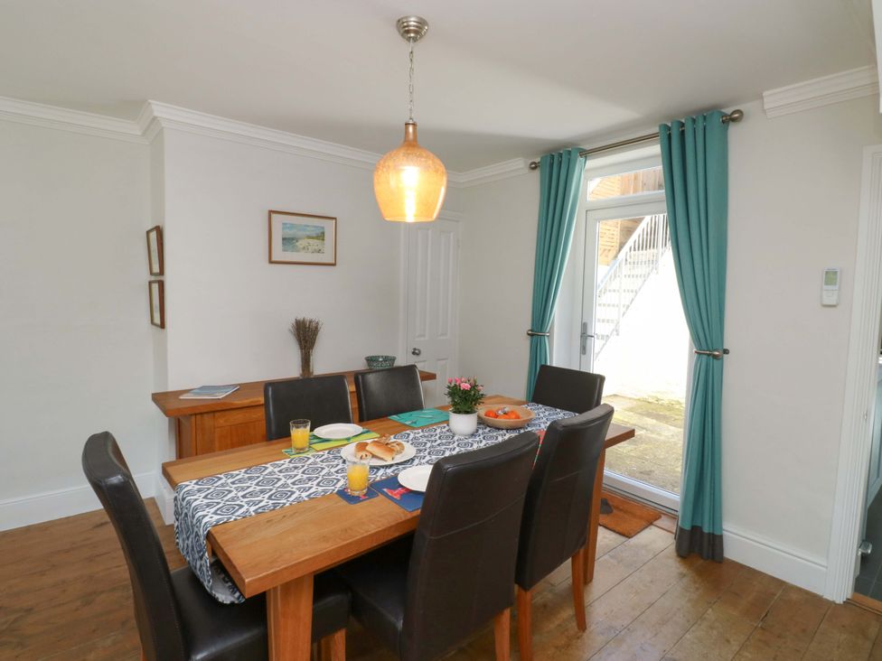 A dining room with a table set for a meal at 43 Sandquay Road Dartmouth