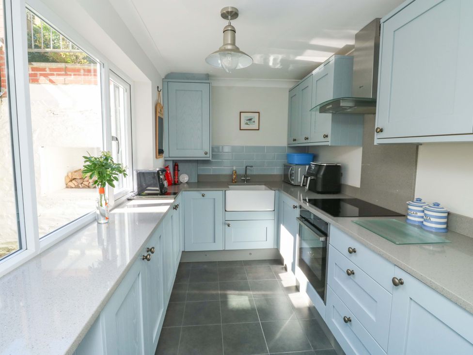 A kitchen with cabinets and appliances at 43 Sandquay Road Dartmouth