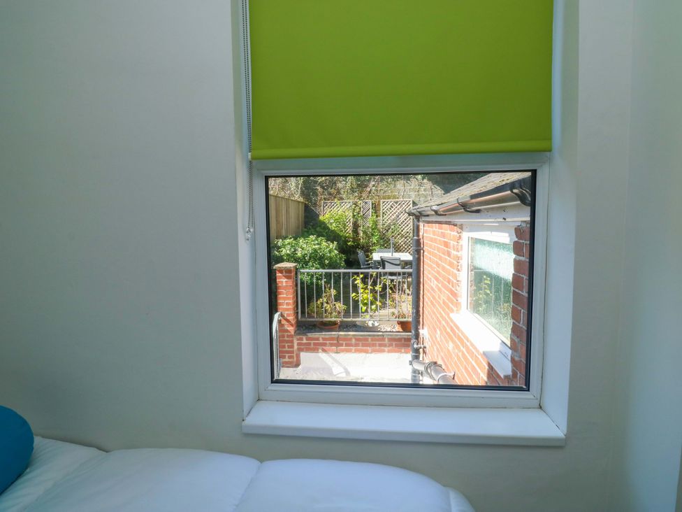 A window view showing a garden area at 43 Sandquay Road in Dartmouth