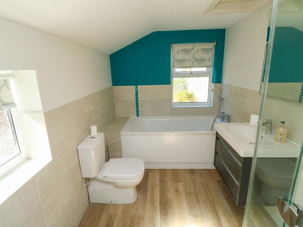 A bathroom with a bath tub and sink at 43 Sandquay Road Dartmouth