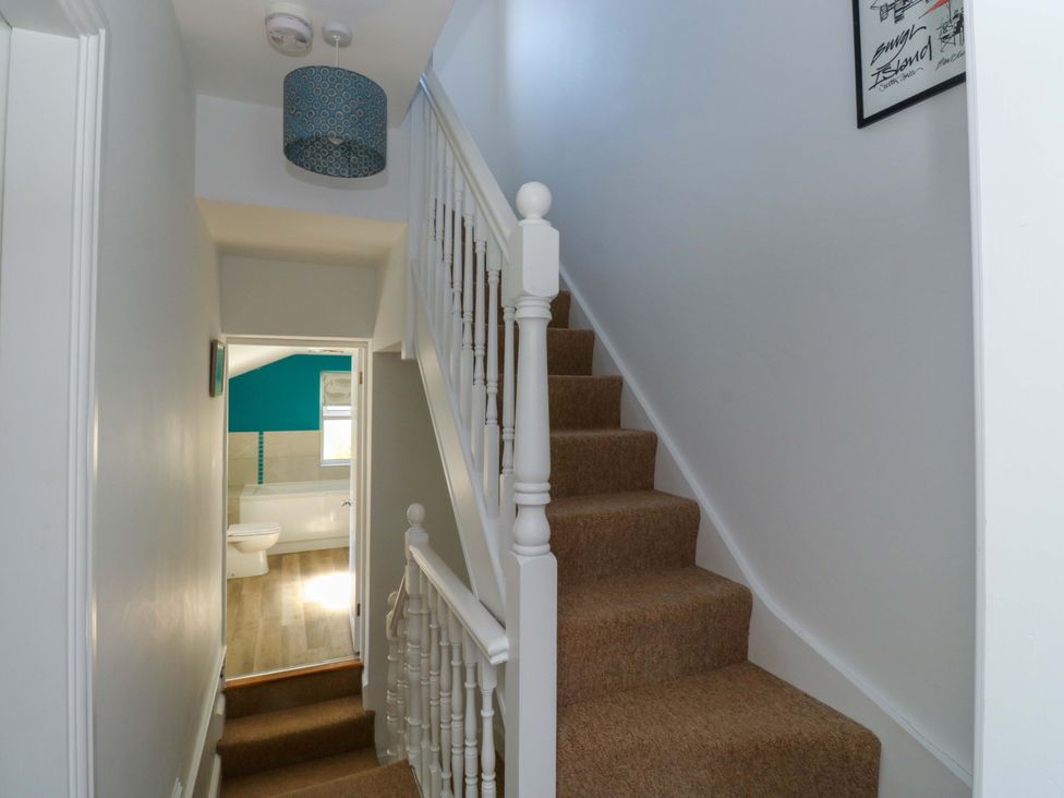 A hallway with staircase and bathroom door at 43 Sandquay Road, Dartmouth