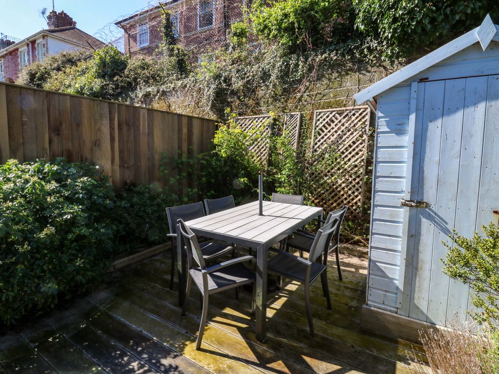A garden with table and chairs beside a shed at 43 Sandquay Road in Dartmouth