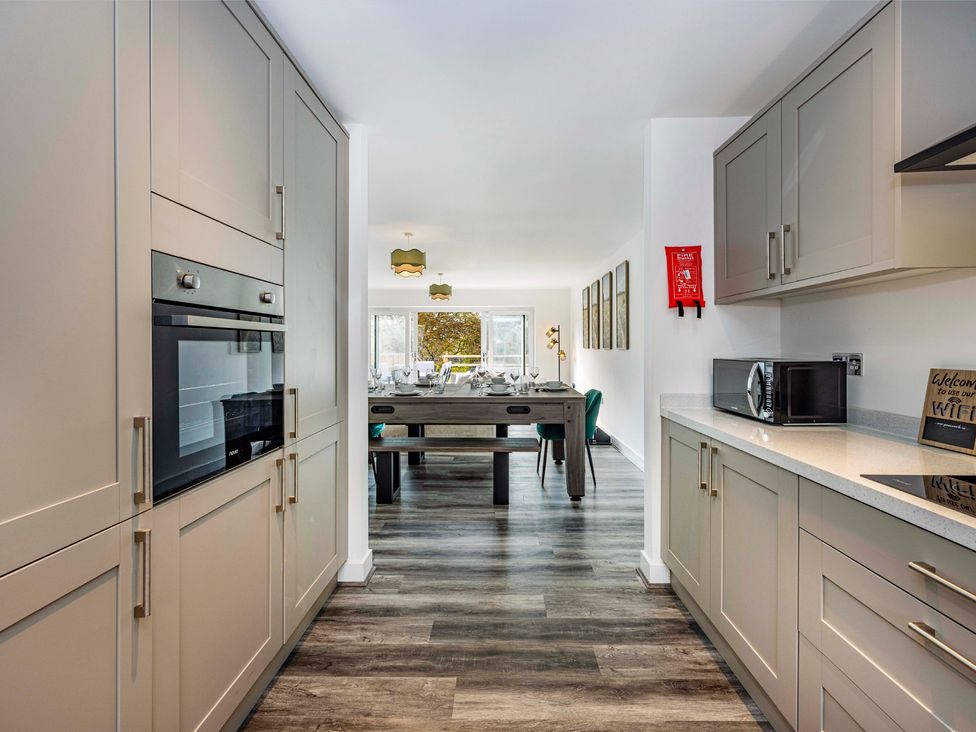 A kitchen with appliances and dining area at 3 Riverside Mews in Derby
