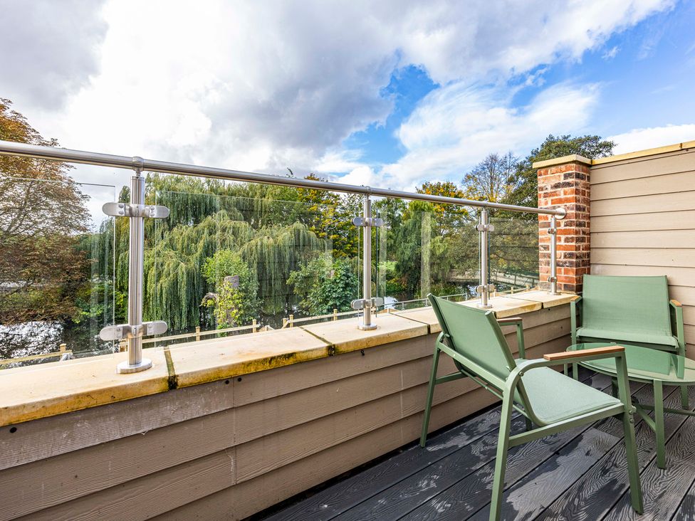 A balcony with chairs and railing at 3 Riverside Mews in Derby