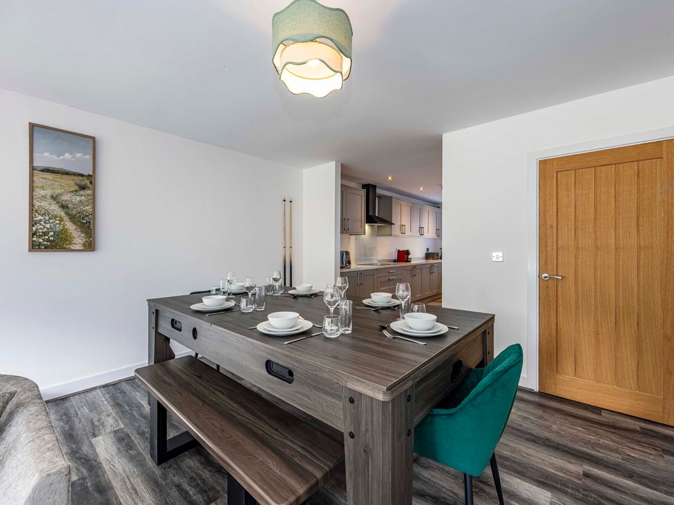 A dining room with a table set for a meal at 4 Riverside Mews in Derby