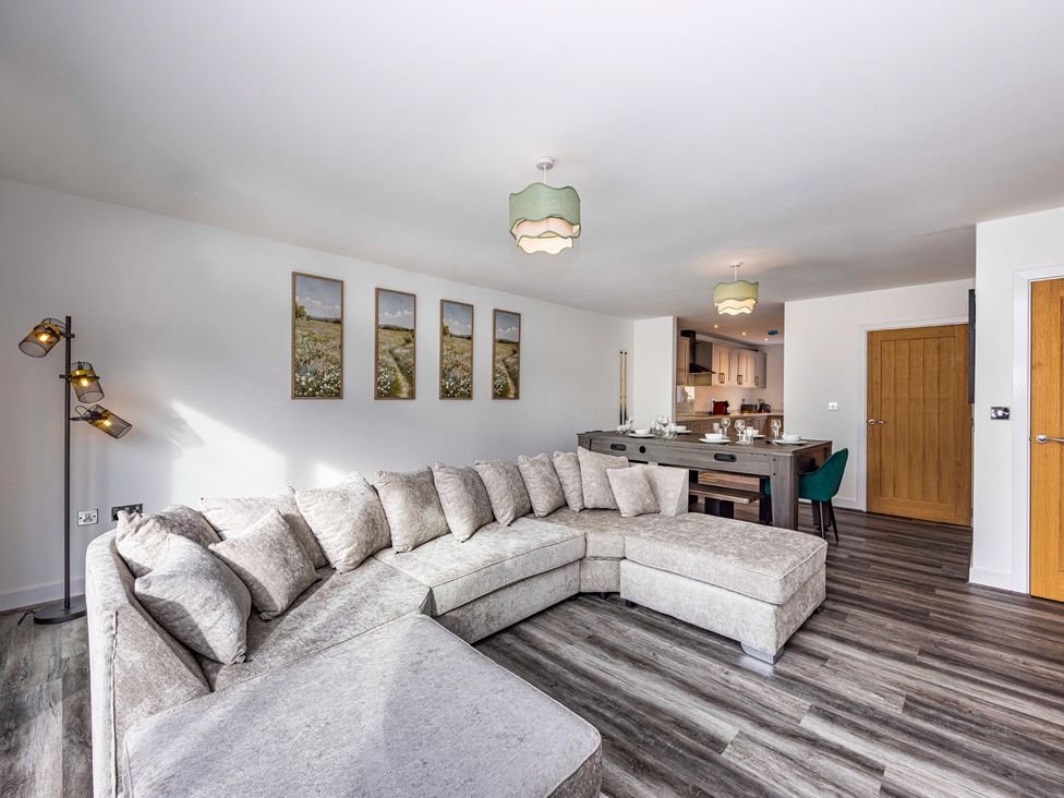 A living room with a sofa and table at 6 Riverside Mews in Derby