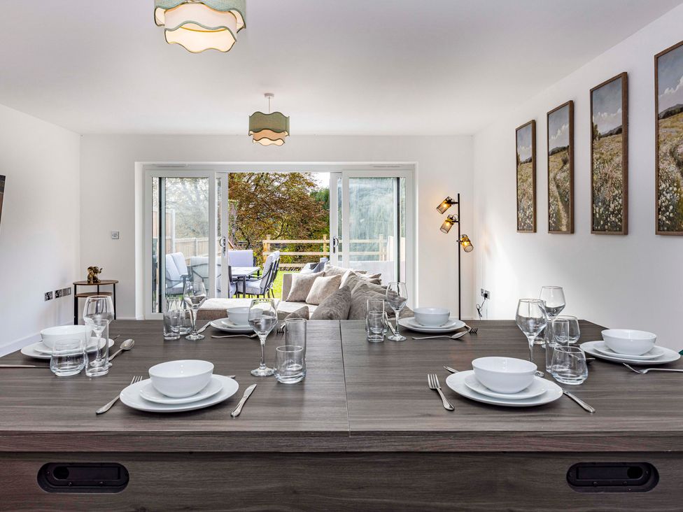 A dining room with a table set for a meal at 6 Riverside Mews Derby