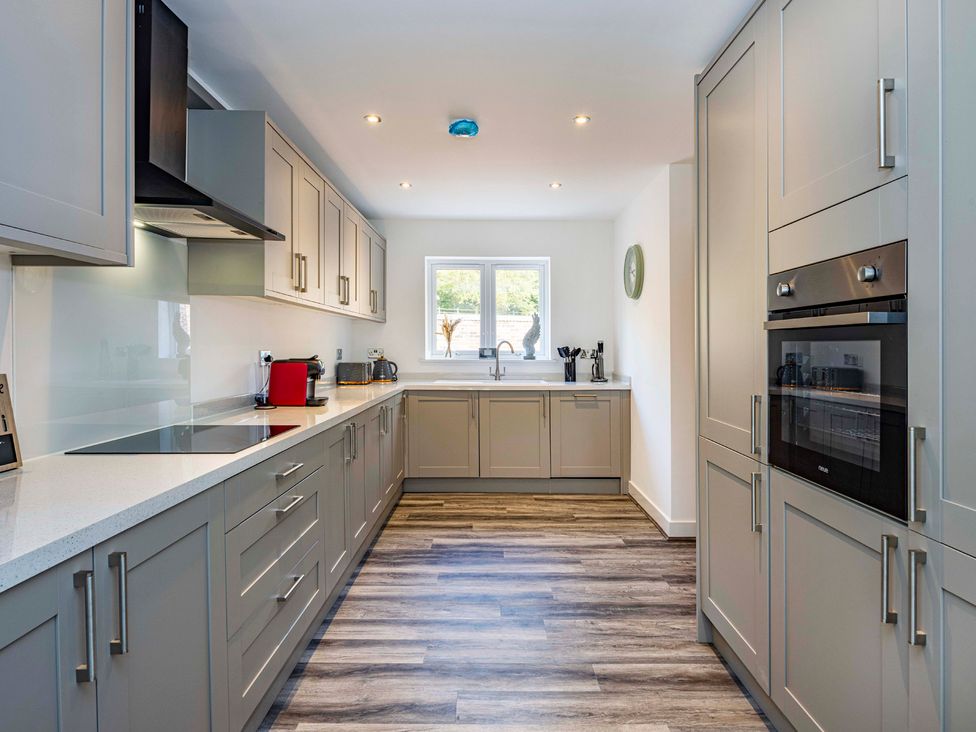A kitchen with cabinets and appliances at 6 Riverside Mews in Derby