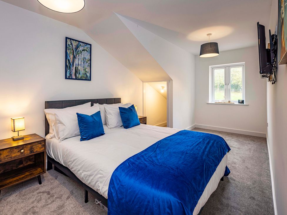 A bedroom with a double bed and a window at 6 Riverside Mews in Derby