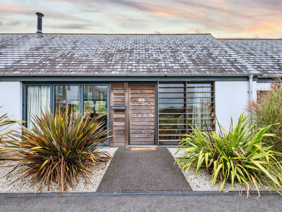 The entrance of Beachcombers Marhamchurch with plants and a pathway