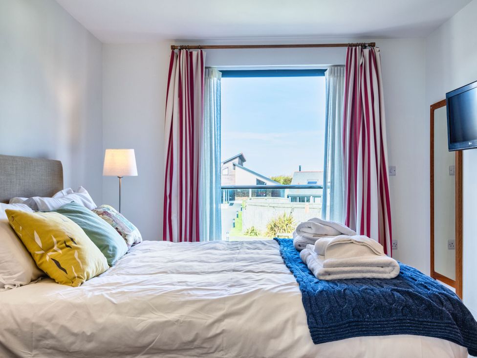 A bedroom with a bed and a window at Chapel Park in Marhamchurch