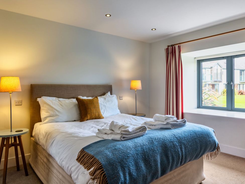 A bedroom with a bed and a window at Little Main in Marhamchurch