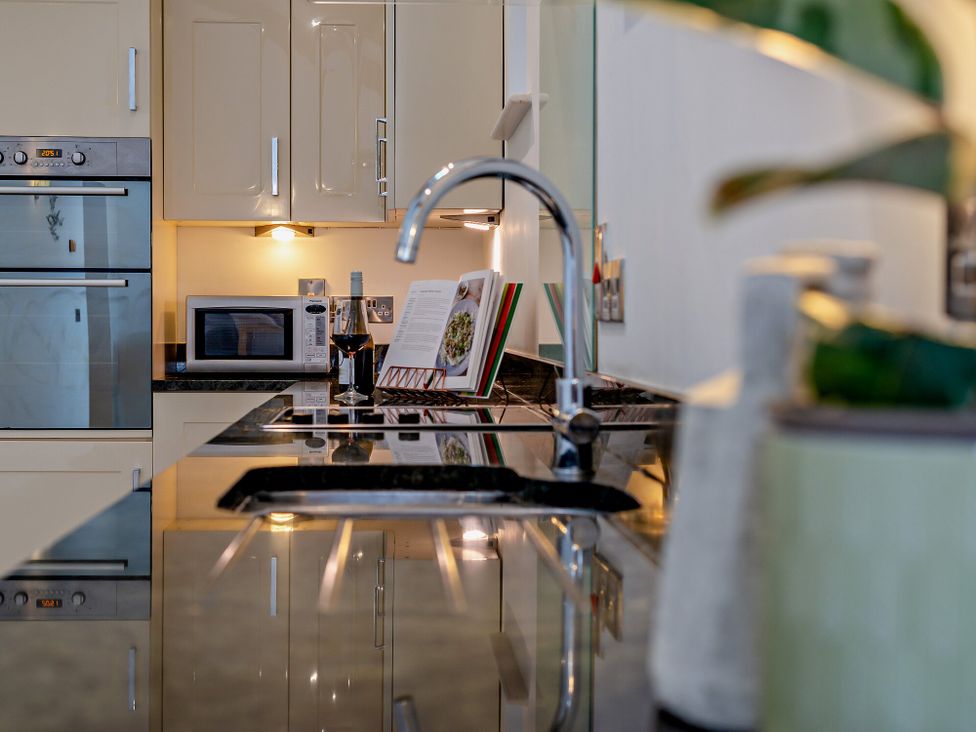 A kitchen with a sink and microwave at Middle Hill in Marhamchurch