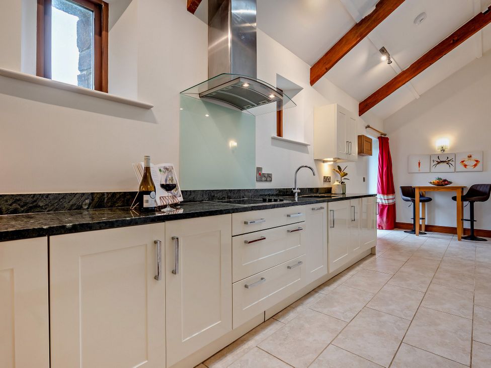 A kitchen with cabinets and sink at Middle Hill in Marhamchurch