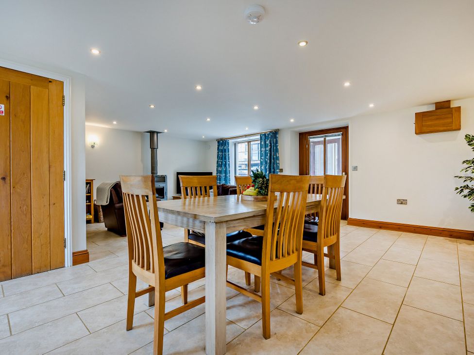 A dining room with a table and chairs at Sand Parks in Marhamchurch