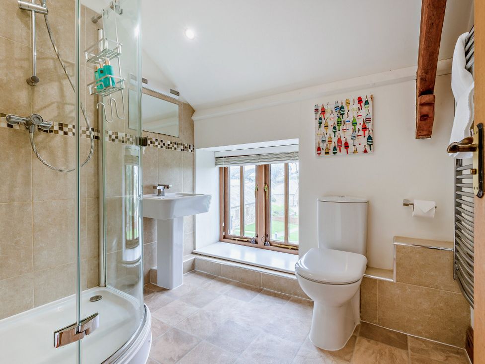 A bathroom with a shower and sink at Sand Parks in Marhamchurch