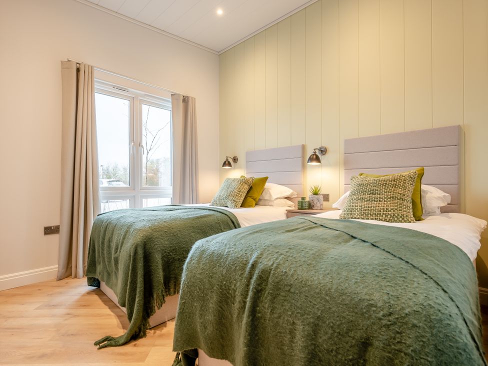 A bedroom with two beds and a window at Trelowen 2.0 Spa in Marhamchurch