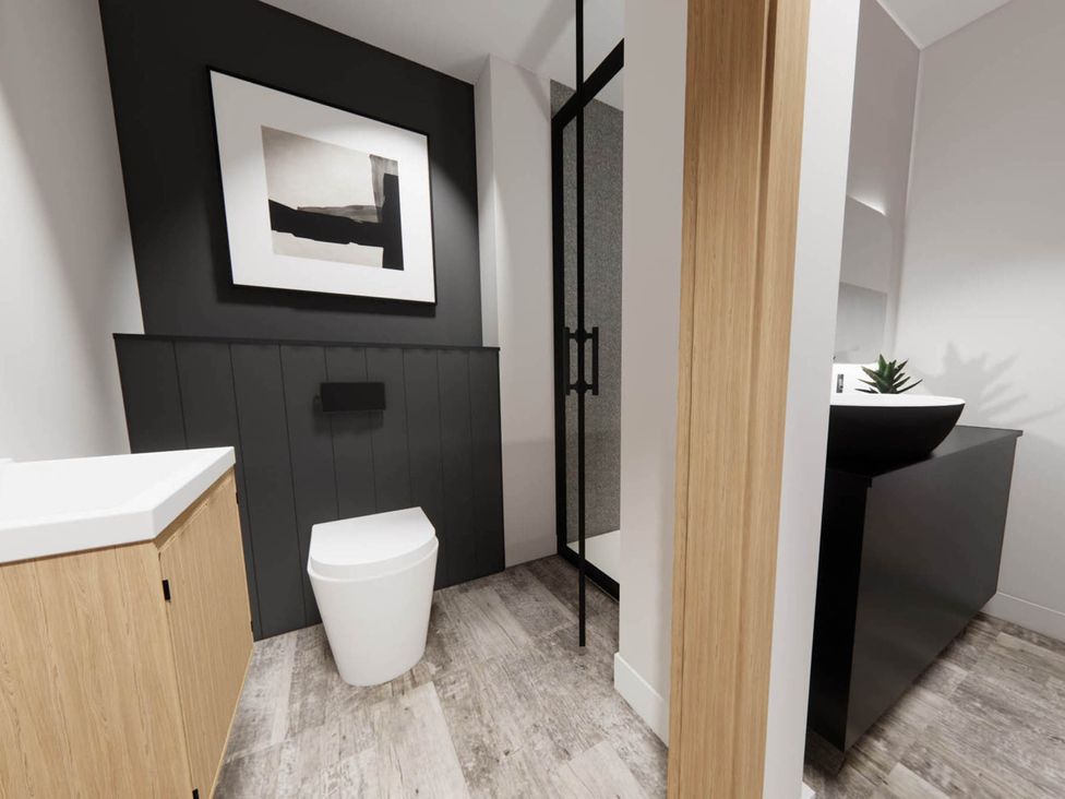 A bathroom with a toilet and sink at Arvor Duplex 2.0 in Marhamchurch
