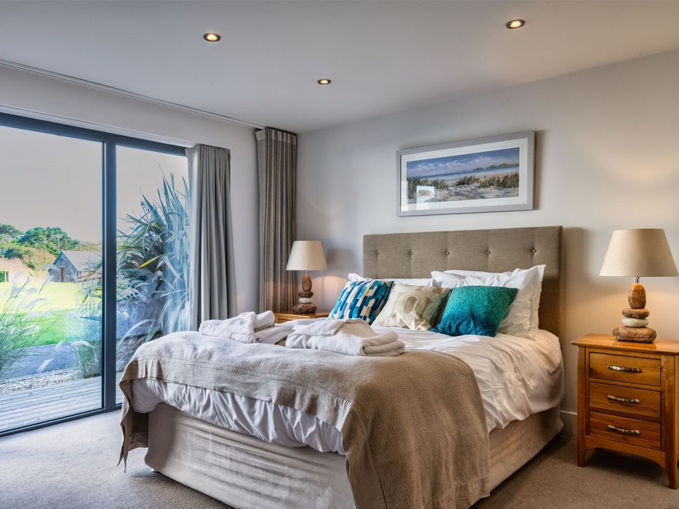 A bedroom with a bed and nightstand at Nettlecoombe Spa in Marhamchurch