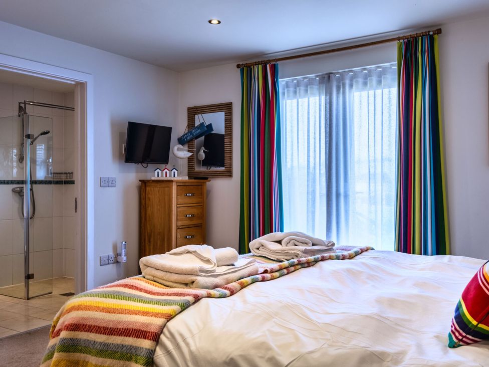 A bedroom with a bed and television at Nettlecoombe Spa Marhamchurch