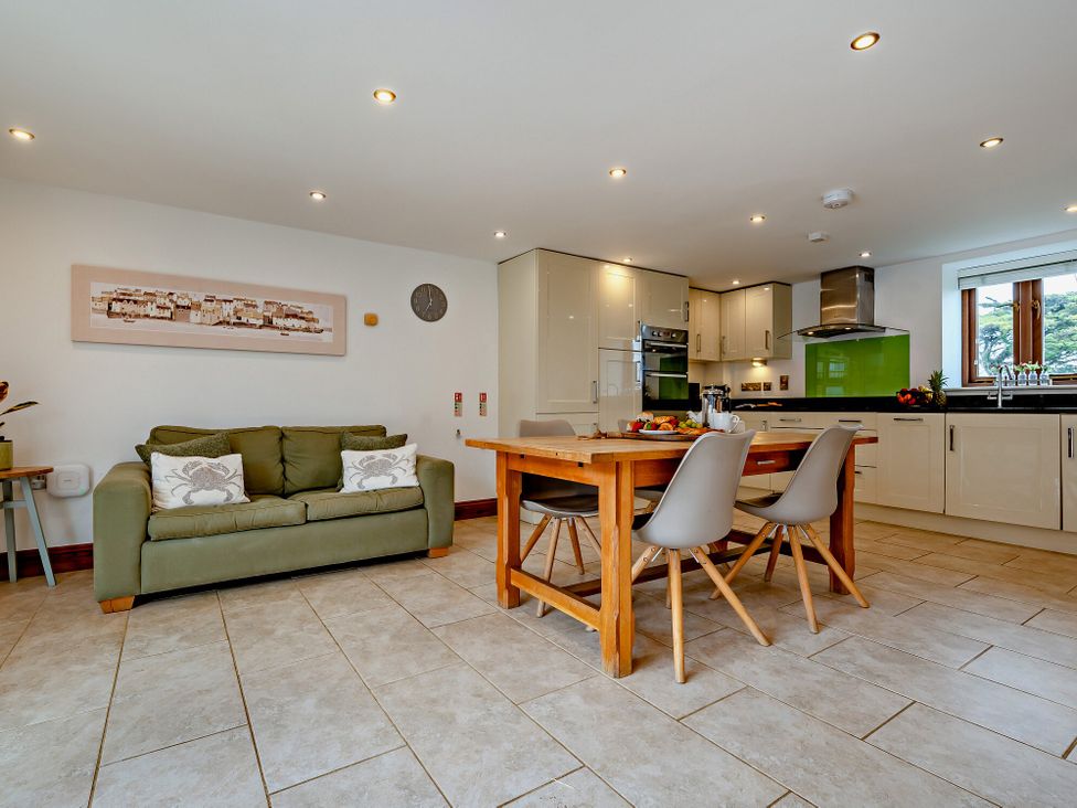 A kitchen with a table and chairs at Jack's House in Marhamchurch