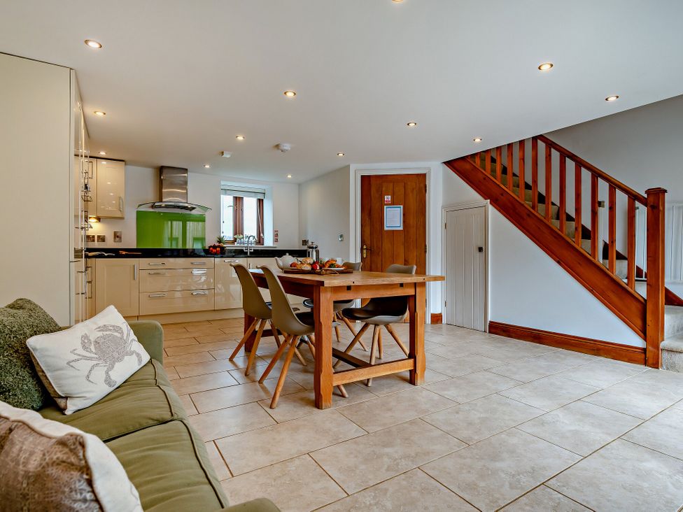 A kitchen with a dining table and chairs at Jack's House in Marhamchurch