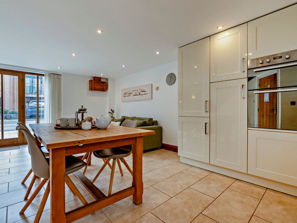 A kitchen with a dining table and chairs at Jack's House in Marhamchurch
