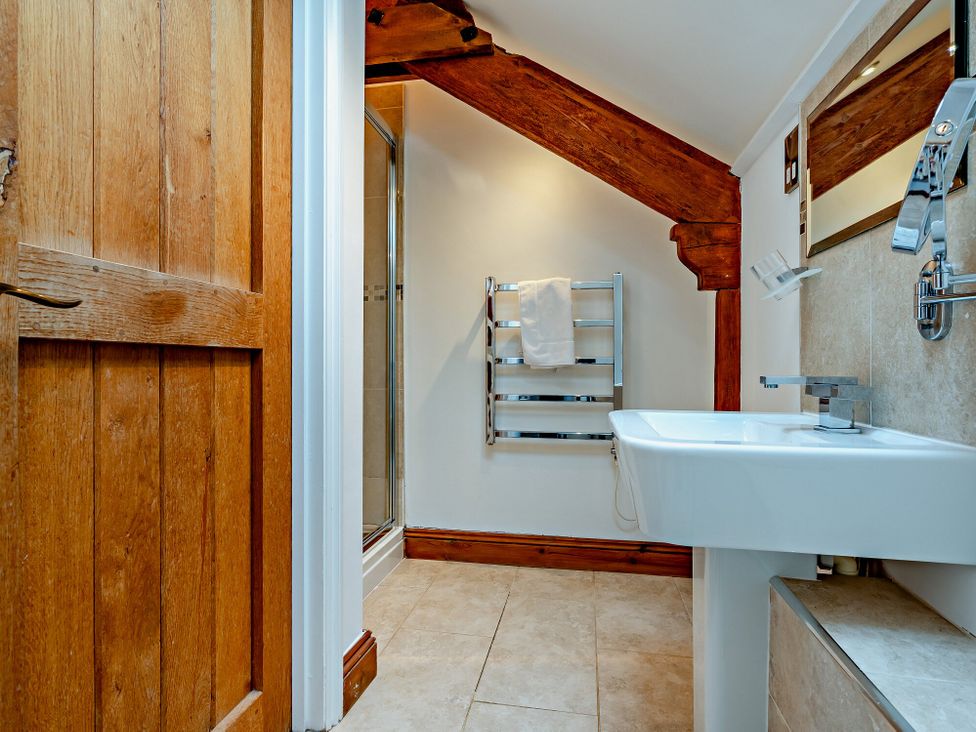 A bathroom with a sink and shower at Jack's House in Marhamchurch