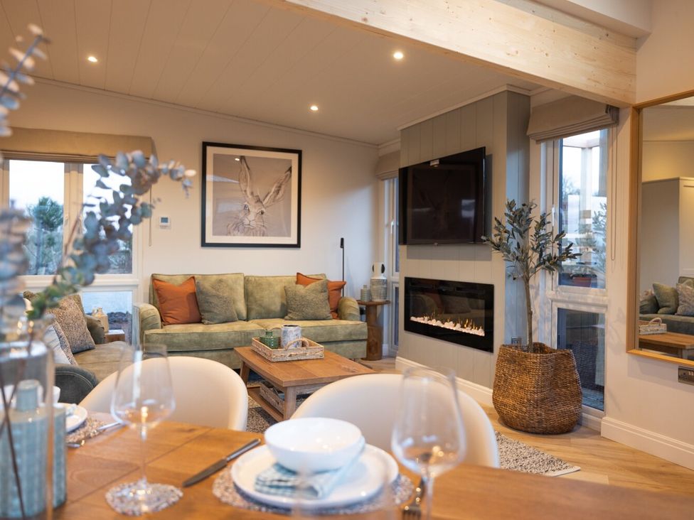 A living room with a sofa and coffee table at Trelowen 4.0 Spa in Marhamchurch