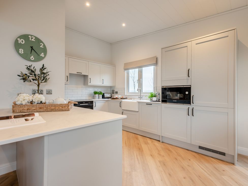A kitchen with appliances and a window at Trelowen 4.0 Spa in Marhamchurch
