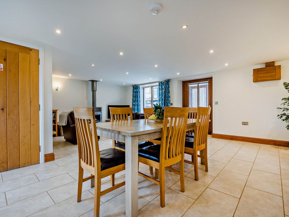 A dining room with a table and chairs at Trelowen 4.0 Spa in Marhamchurch