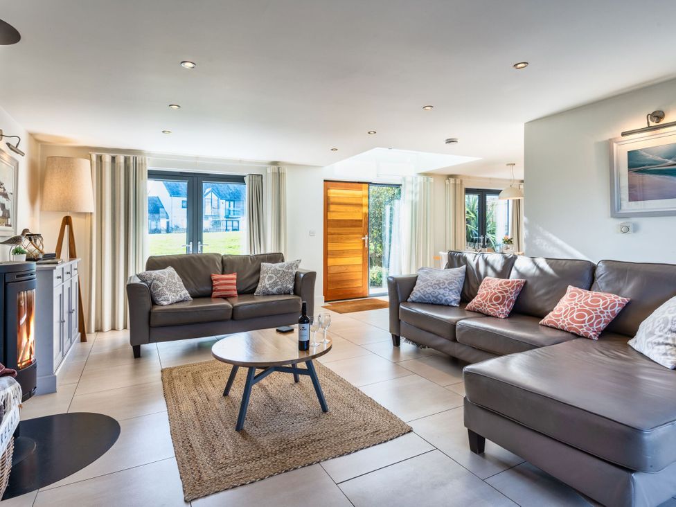 A living room with a sofa and coffee table at Arundell in Marhamchurch
