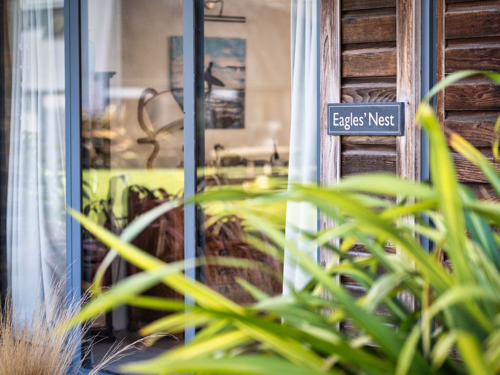 An outdoor view of a window and sign at Eagle's Nest in Marhamchurch
