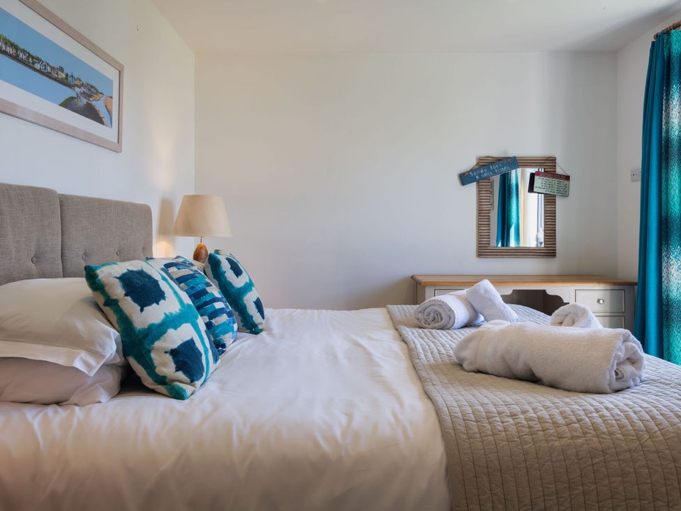 A bedroom with a bed and desk at Eagle's Nest in Marhamchurch