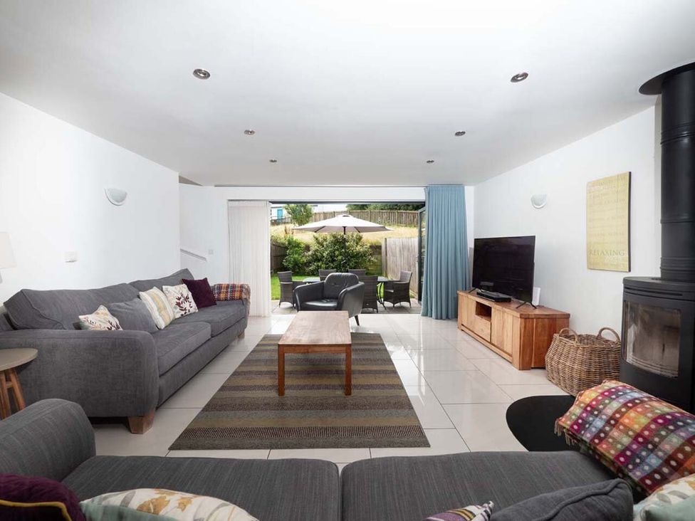 A living room with a sofa and coffee table at Medlands in Marhamchurch