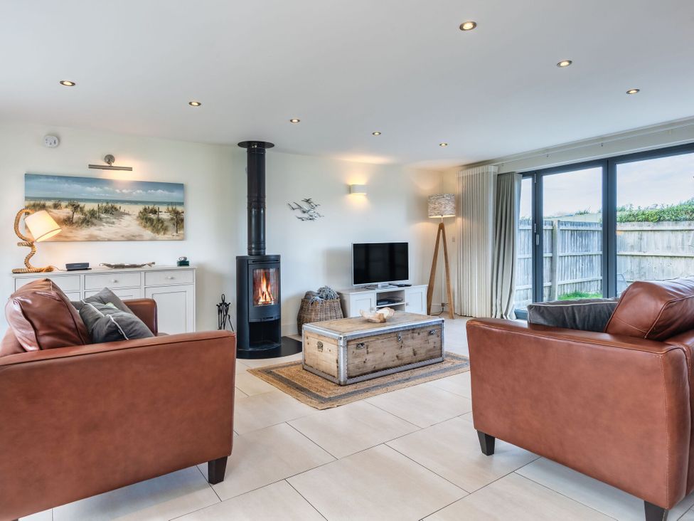 A living room with a fireplace and sofa at Moleyns in Marhamchurch