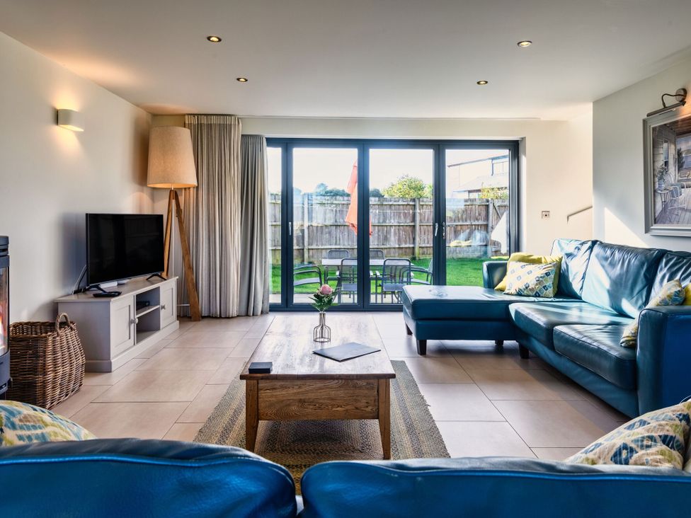 A living room with a sofa and coffee table at Trevelyan in Marhamchurch
