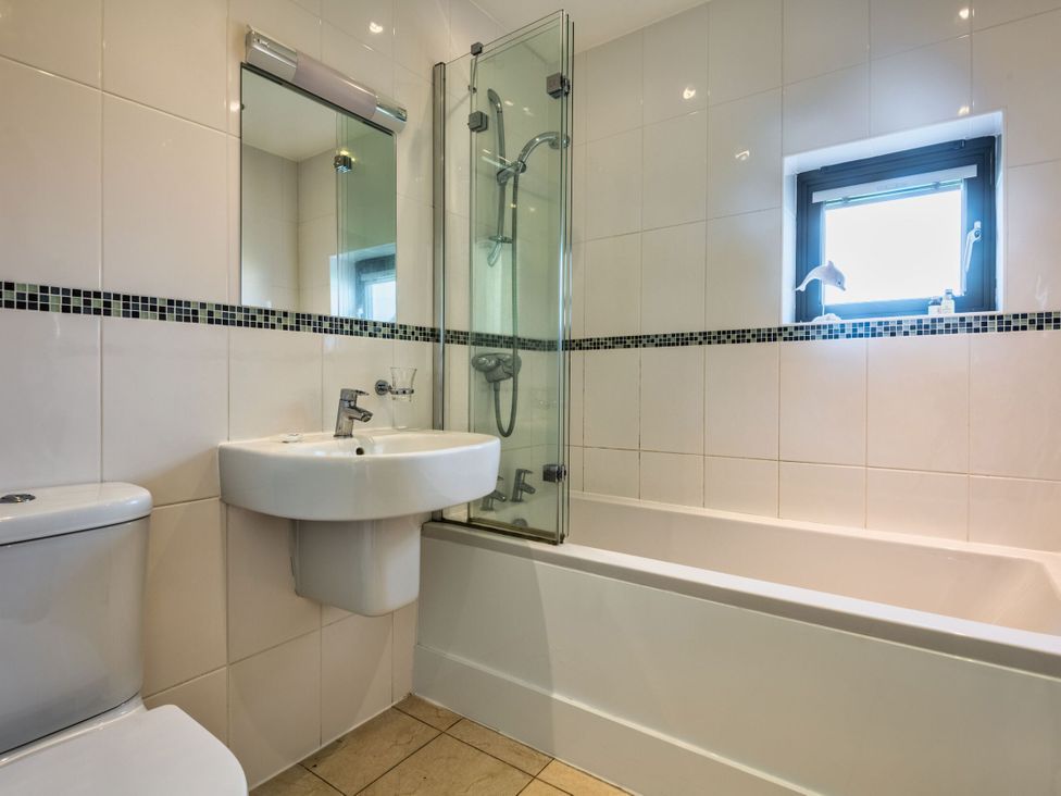 A bathroom with a toilet sink bathtub and shower at Trevelyan in Marhamchurch