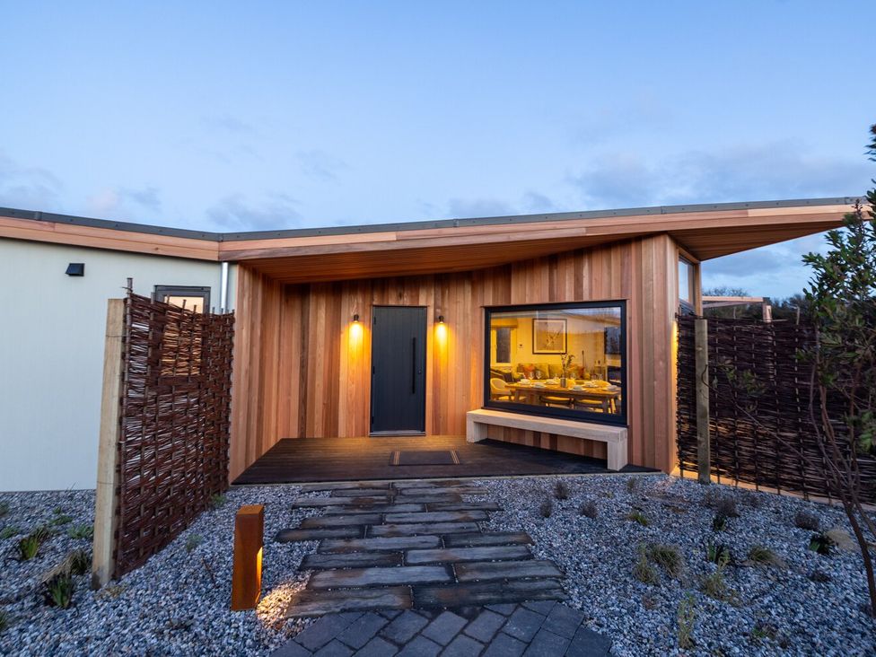 A modern house entrance with a pathway at Trelowen 3.0 Spa in Marhamchurch
