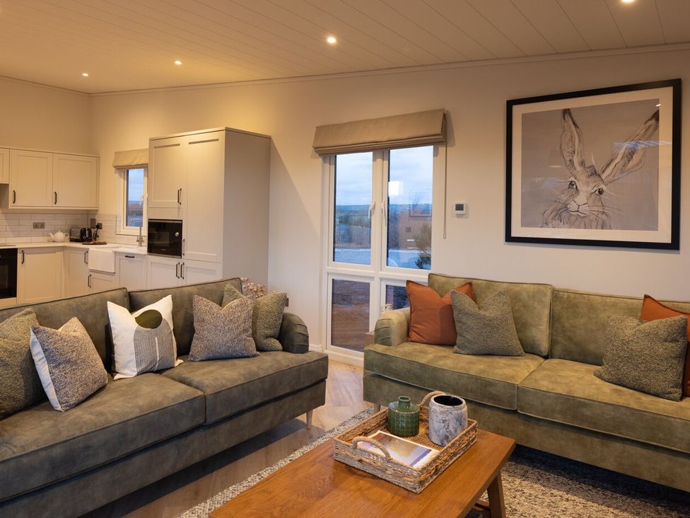 A living room with sofas and a coffee table at Trelowen 3.0 Spa in Marhamchurch