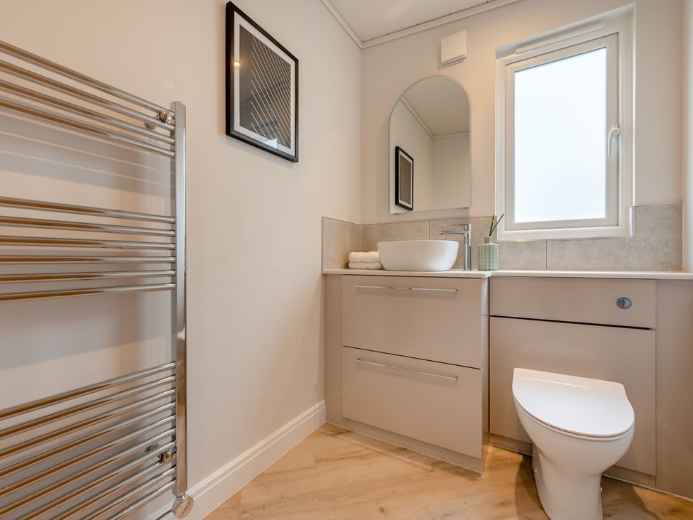 A bathroom with a sink and toilet at Trelowen 3.0 Spa in Marhamchurch