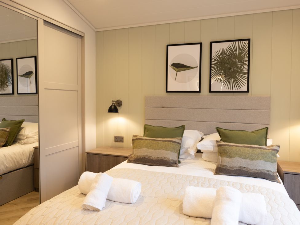 A bedroom with a bed and pillows at Trelowen 3.0 Spa in Marhamchurch