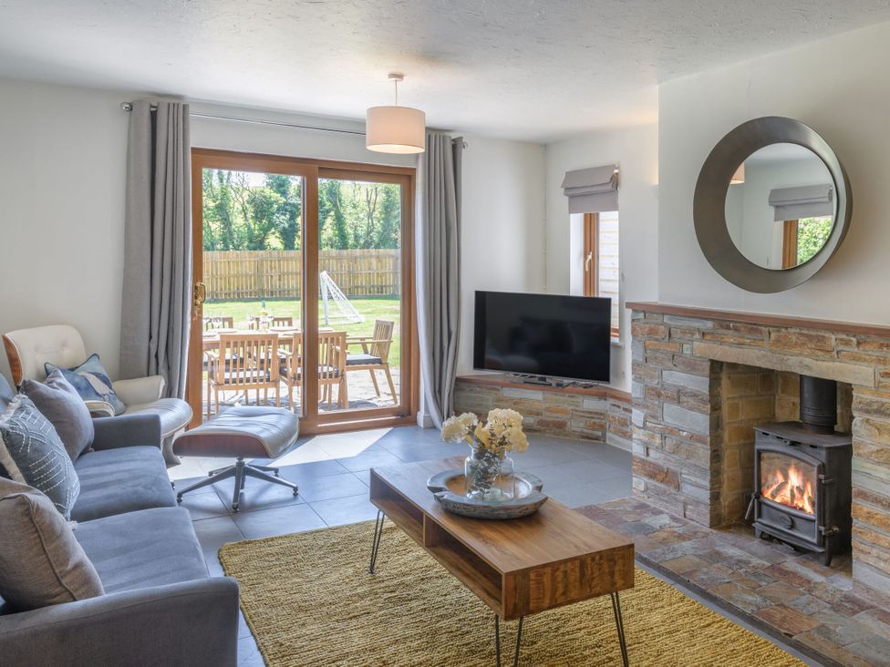 A living room with a sofa and coffee table at Windy Hills Spa, Marhamchurch