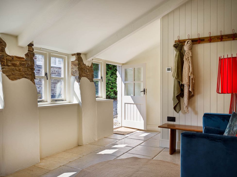 An entryway with a door and windows at Whalesborough Farmhouse Spa Marhamchurch