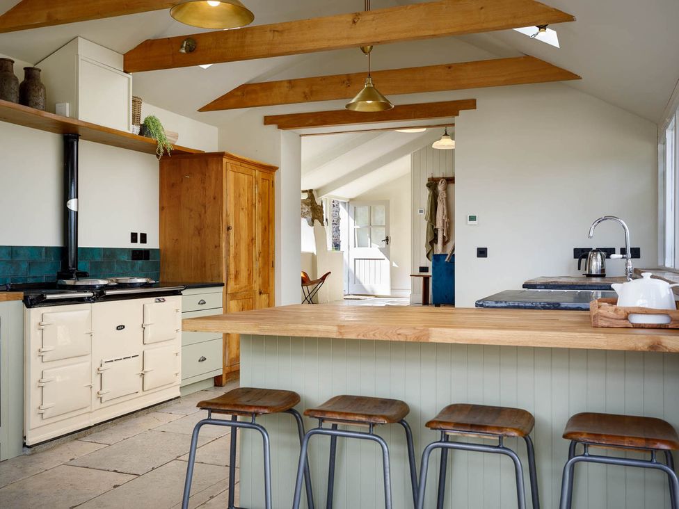A kitchen with a stove and countertop at Whalesborough Farmhouse Spa Marhamchurch