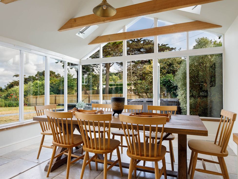A dining area with a table and chairs at Whalesborough Farmhouse Spa Marhamchurch