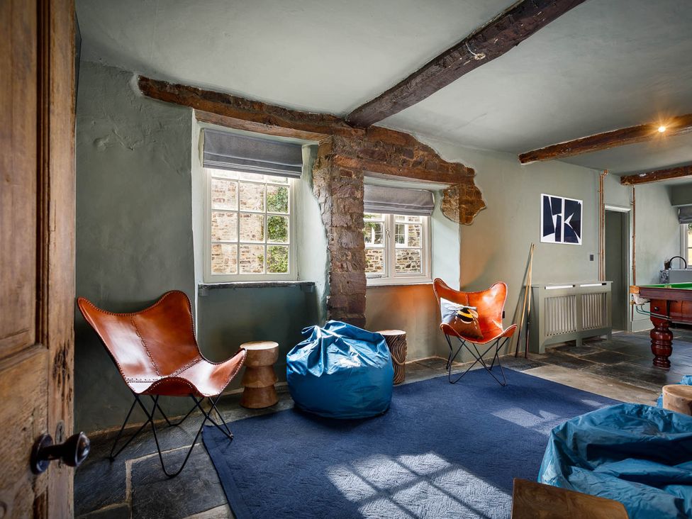 A snug with an armchair and bean bag at Whalesborough Farmhouse Spa Marhamchurch