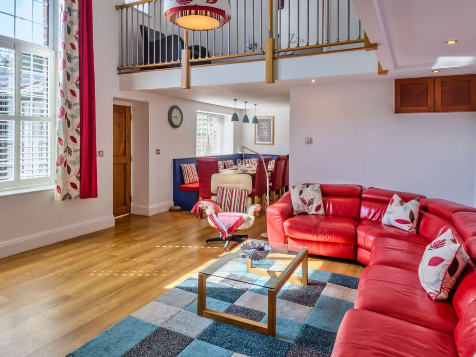 A living room with a sofa and coffee table at Calf House Spa Marhamchurch