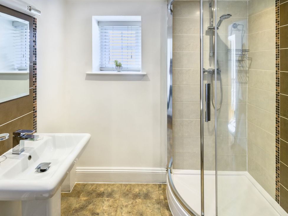 A bathroom with a sink and shower at Calf House Spa in Marhamchurch